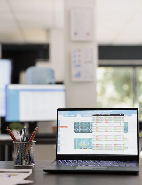 Analysis of financial statistics on laptop with graphs for business planning, stock market investment strategy. Portable computer with financial data analysis system in a modern office.